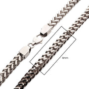 A close-up of the 4mm Steel Franco Chain by INOX reveals a shiny, interlinked design. This men's stainless steel necklace is fastened with a lobster clasp and features a section measuring 4mm in width, highlighted by a rectangular outline.