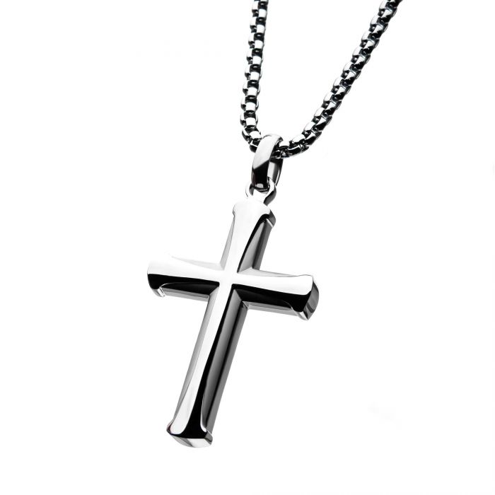A close-up photograph of the INOX Stainless Steel Apostle Cross Pendant hanging on its bold box chain. The polished silver cross boasts rounded edges and a smooth surface, while the chain features small, square links. The plain white background enhances the simplicity of this men's stainless steel jewelry from INOX.