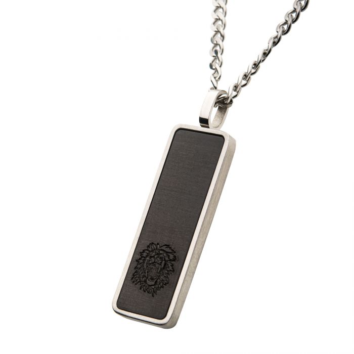 Introducing the INOX Carbon Fiber & Steel Dog Tag Pendant, featuring a rectangular black pendant with a lion head engraving at the bottom, encased in a sleek silver frame and suspended from a 24-inch steel curb chain. This sophisticated piece is part of our Carbon Fiber & Steel Jewelry collection and embodies both strength and elegance.
