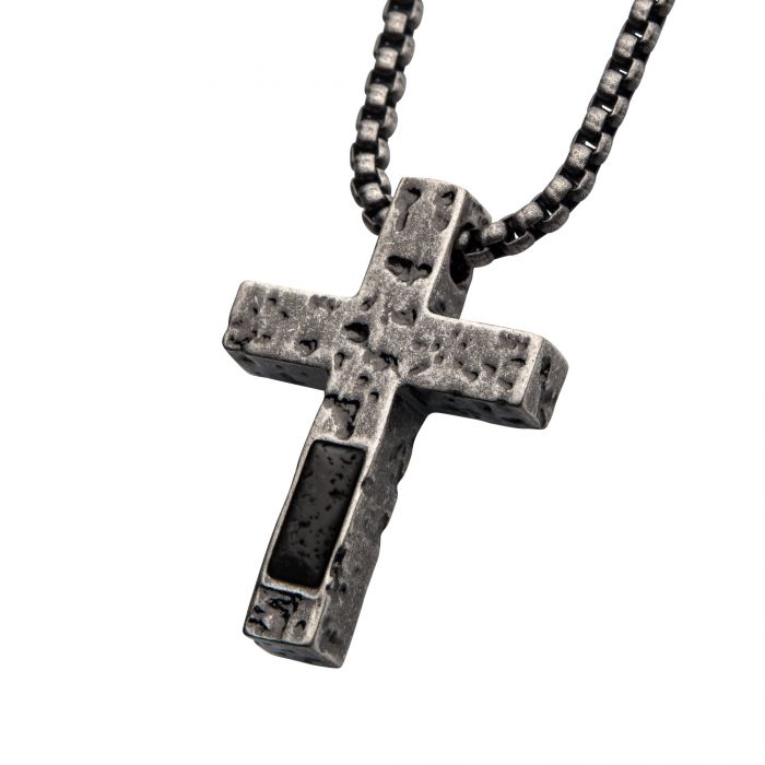 The INOX Stainless Steel Silver Plated Cross Pendant with Lava Stone Pendant, paired with a sturdy steel box chain, exudes rugged elegance. This men's jewelry piece features a textured steel design and an eye-catching black lava stone inset, offering a rustic and weathered aesthetic ideal for those who appreciate robust sophistication.