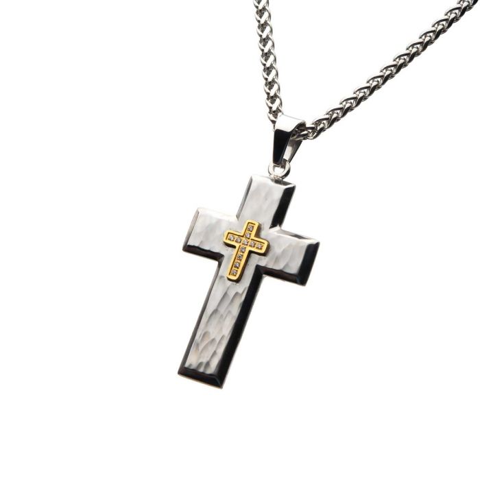The INOX Gold Plated Cross with Wheat Chain (24") features a silver cross necklace with a smaller gold-plated cross bearing engraved text at the center. The steel hammered cross pendant hangs on a thick wheat chain, adding unique texture and durability to this stunning piece.