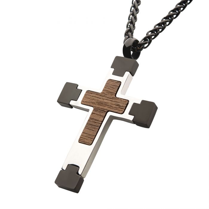 An INOX Steel Cross Pendant featuring a Walnut Wood Inlay, accented with black and silver metal elements, elegantly hanging from a sleek Black Wheat Chain necklace.