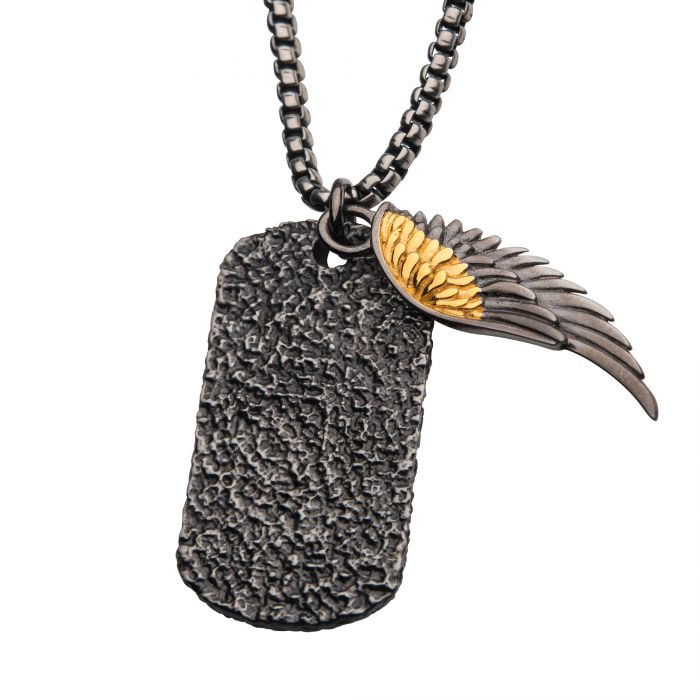 The INOX Layered 18K Gold IP Wing & Gun Metal IP Dog Tag Pendants with Round Box Chain features a ruggedly stylish gun metal dog tag pendant hanging on a round box chain, paired with a wing charm showcasing intricate feather details highlighted with 18K gold plated accents, attached by a sturdy metal ring.