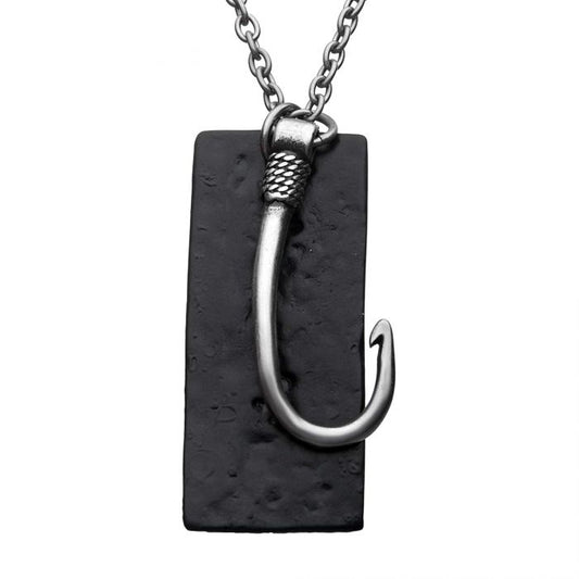 The Stainless Steel Antiqued Finish Fish Hook and Black Plated Tag Pendant with chain by INOX features a men's stainless steel chain attached to a silver-colored fish hook pendant with textured details near the top, which dangles over a rectangular black plated tag.