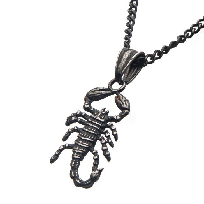 The Men's Stainless Steel Antique Gunmetal Scorpion Pendant by INOX is a striking black metal necklace. It boasts a detailed scorpion pendant with raised pincers, a segmented body, and a curved tail. The pendant hangs from a medium-thick gunmetal box chain featuring interconnected links that beautifully complement and highlight the intricately designed scorpion's distinctive features, measuring 22" in length.