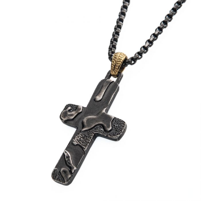 The Stainless Steel Gun Metal Plated 3D Canyon Pattern Pendant from INOX features a black cross with a textured surface hanging from a matching 24" black chain. The men's pendant showcases a rustic design with irregular patterns and is attached to the chain by a gold-colored loop, giving it a modern and edgy look.